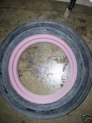 A farmall front rim and tire