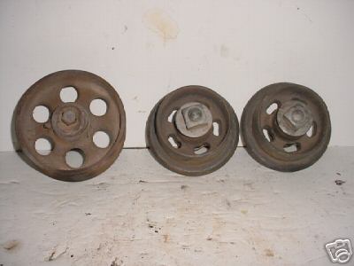4 old cast iron chain or belt guide pulleys 