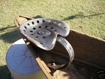 Big old cast .iron ,implement,tractor seat with arm 